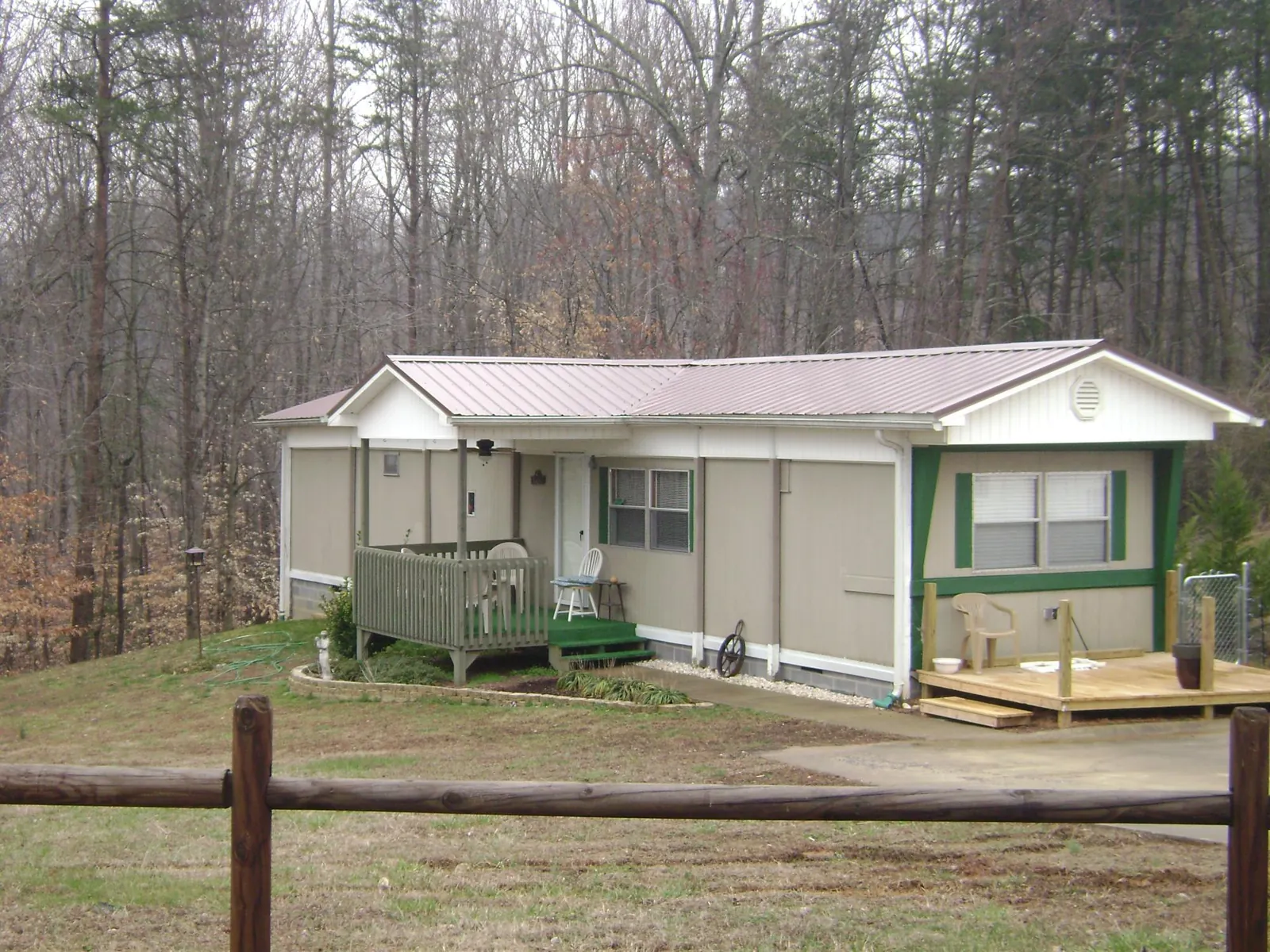 Mauve metal roof on a manufactured home with a new front deck in Glenwood Landing